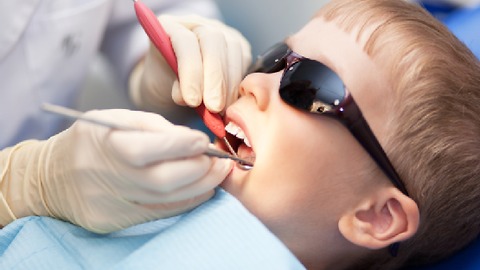 Boy gets his second needle at the dentist.