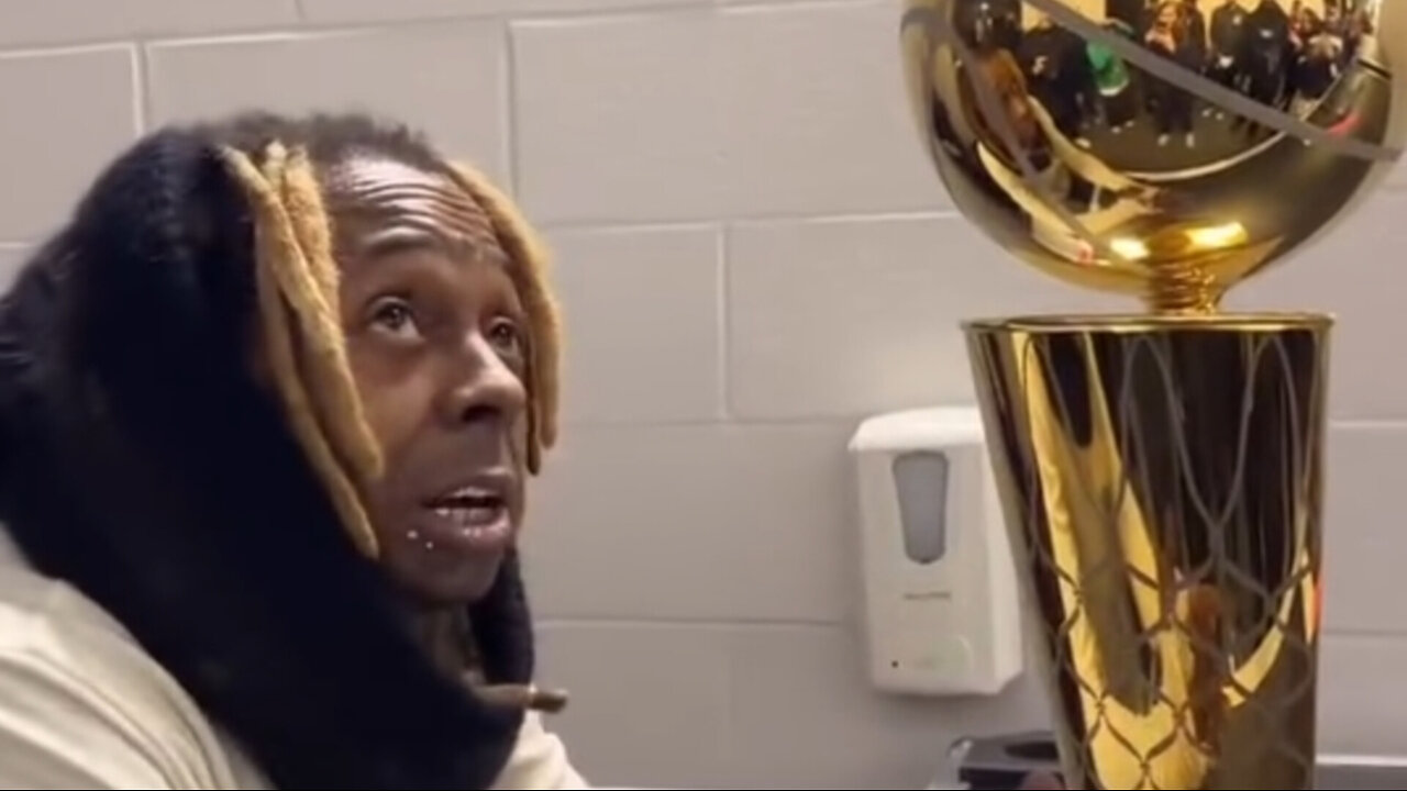 Lil Wayne talking to the NBA trophy