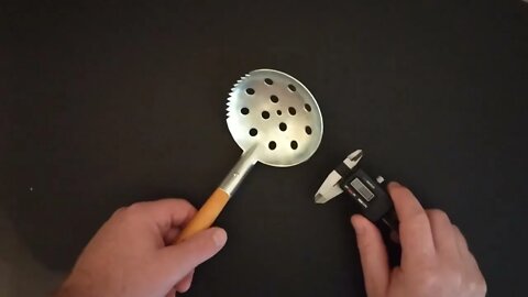 Ice Fishing Scoop with wood and metal construction.