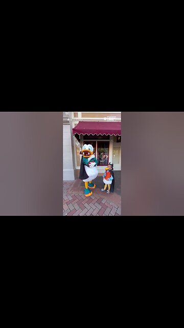 Donald Duck teaches young boy how to shake his tail