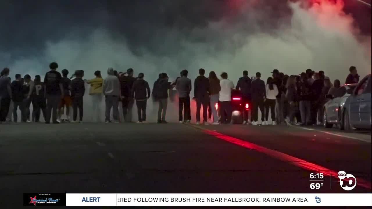 Large crowds gather as cars do donuts in Lincoln Park
