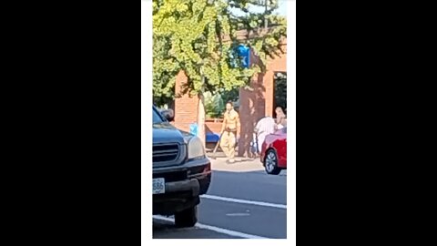 Shirtless Man Wielding Stick On Downtown Portland Sidewalk