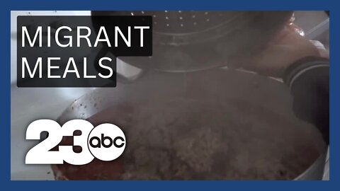 2 women cook hot meals for migrants