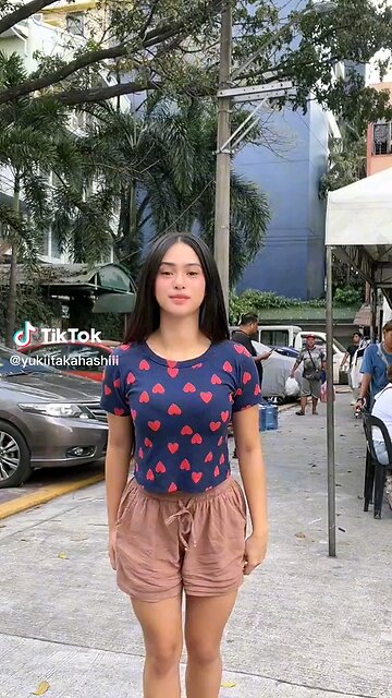 Graceful Beauty in Motion" A stunning Filipina woman with long, flowing black hair sways elegantly