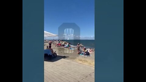 Russians relaxing on the beach watch in fear the explosions on the Crimean bridge