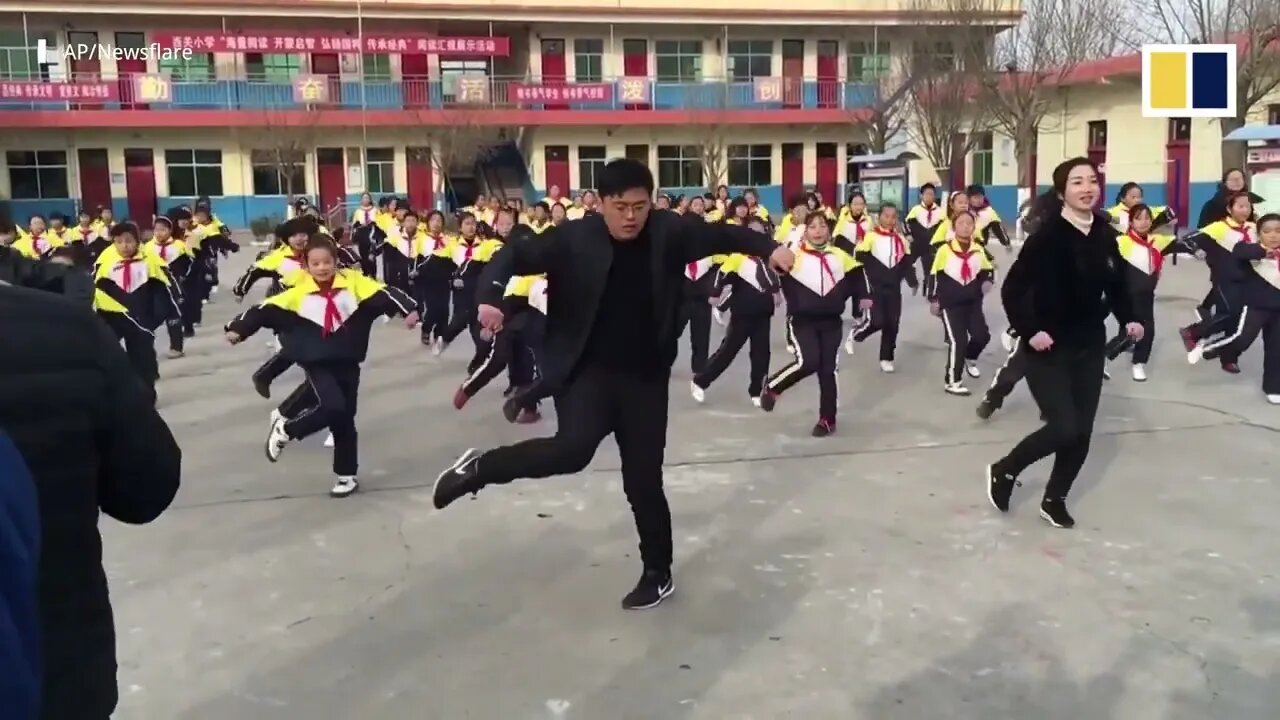 Chinese school principal and students shuffle dance during break