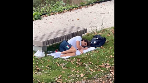 Italian gold medal-winning swimmer Thomas Ceccon sleeping next to park bench.