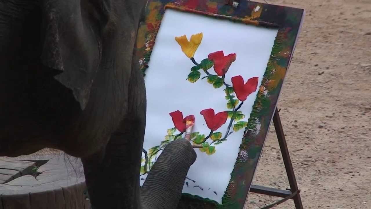 The elephant is working as a painter