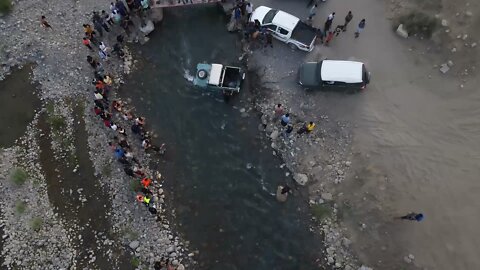 land rover defender in river