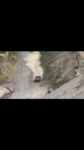 Racing vehicle literally comes inches from hitting spectator