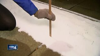 Lauren Winfrey measures about 2 inches of fresh Halloween snow
