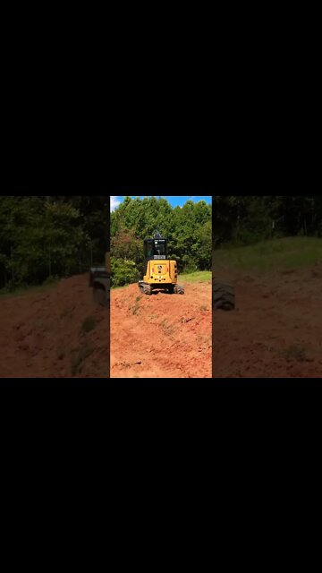 Tiny cute excavator doing big earthworks