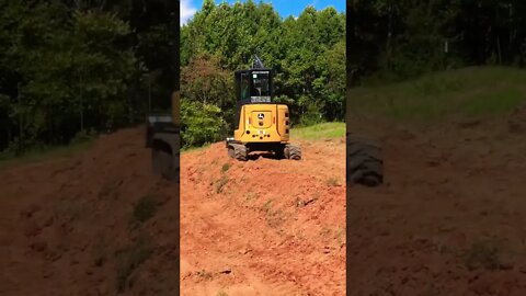 Tiny cute excavator doing big earthworks