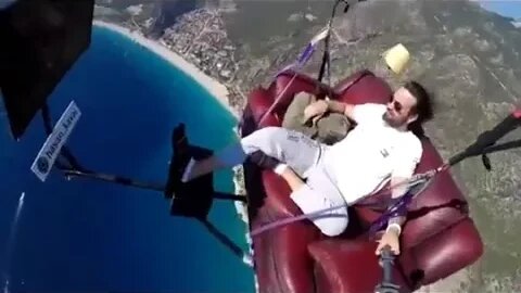 Man attempts to paraglide with couch