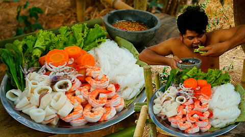 Cooking Seafood and Noodle Eating With Chili Sauce