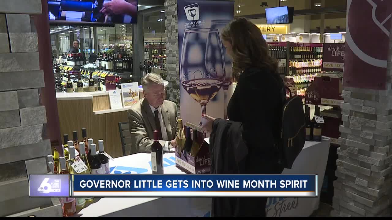 Governor Brad Little signs bottles of wine for Idaho Wine Month