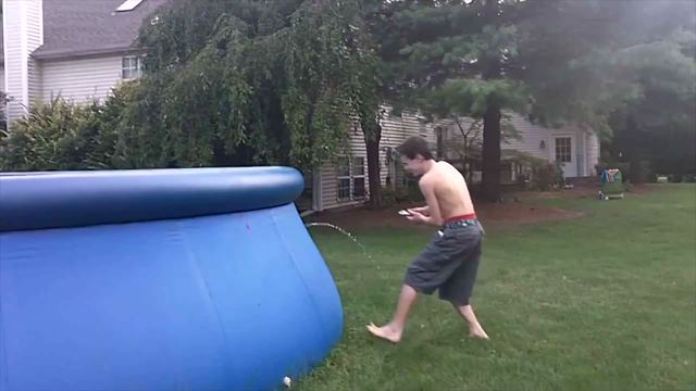 Young Boy Pokes And Pops A Soft Backyard Pool