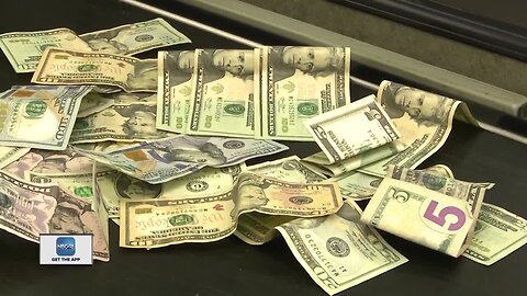 Multiple bundles of money found on floor of grocery store