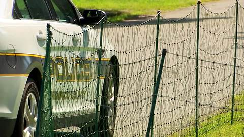 A man put up an electric fence near a school bus stop to keep kids off his lawn