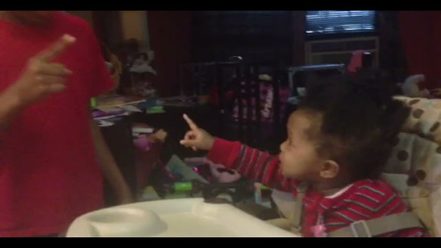 A Baby Girl "Argues" With Her Brother From Her High Chair