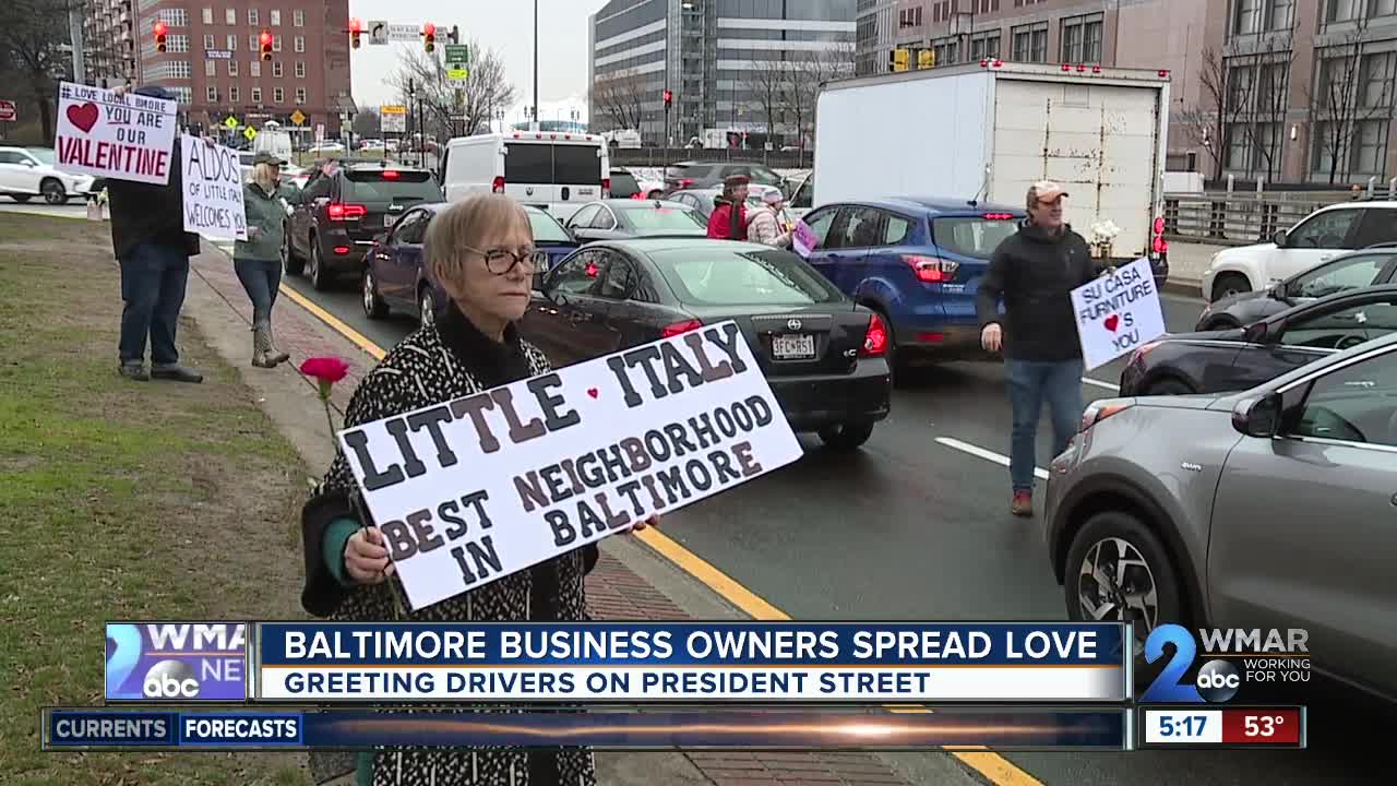 Baltimore business owners spread love by greeting drivers on President Street