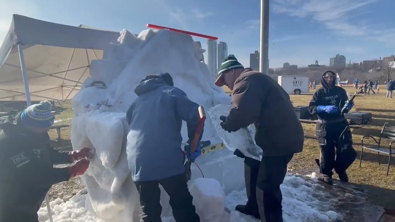 Sculptora Borealis carving snow at the Cool Fool kite festival