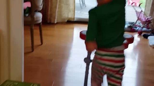 Tot Boy Rockstar Plays With A Toy Drum Set