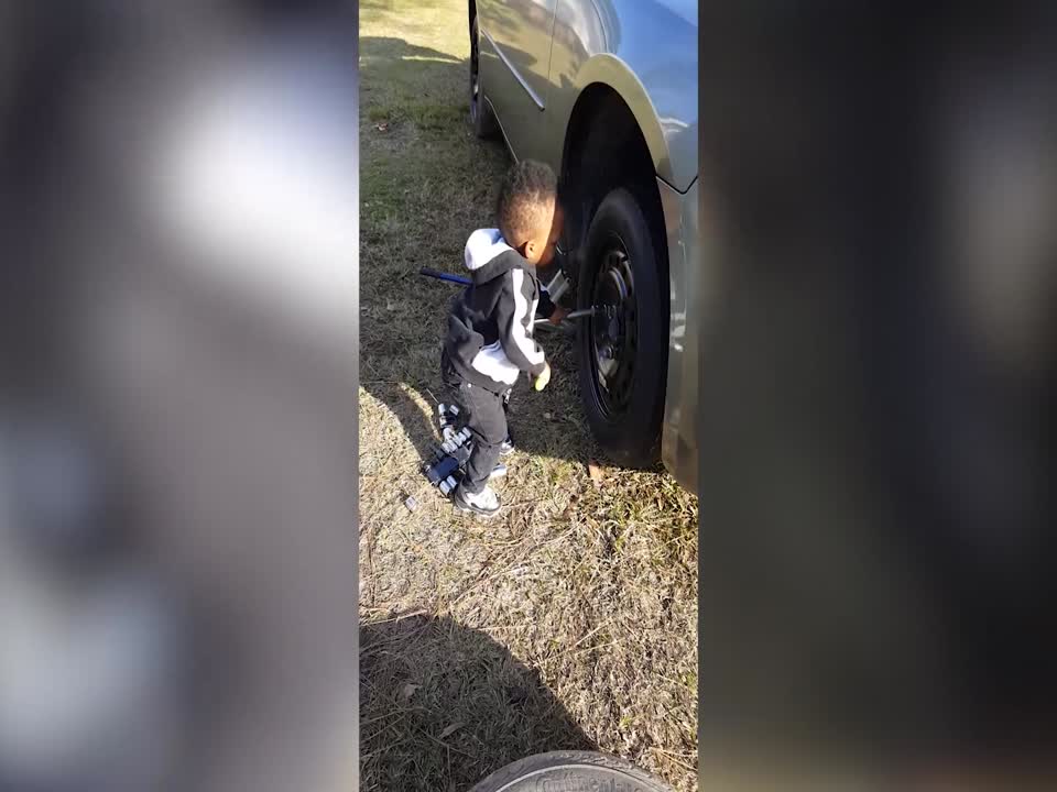 Small Boy Learns about Fixing Tires