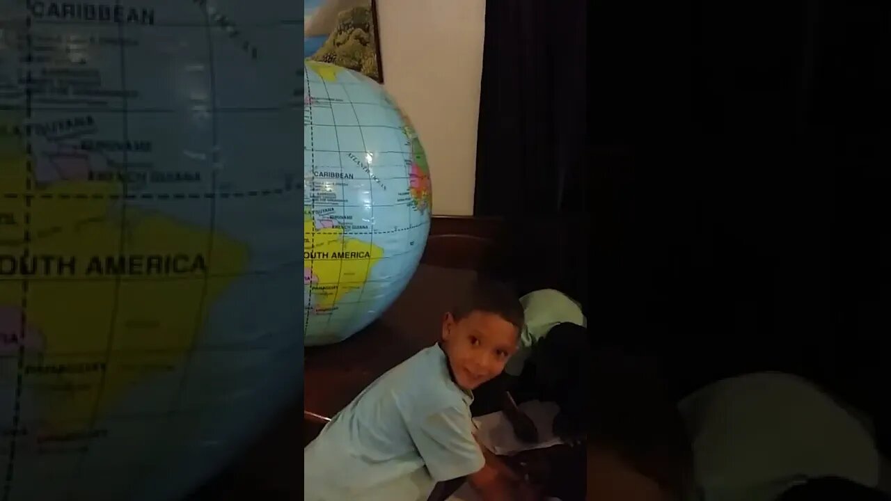 Milo & TJ Study the Inflatable Globe