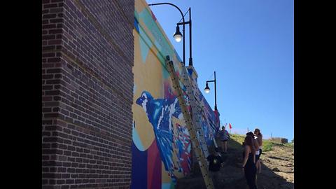 Akron students leave their mark on city with a colorful mural on Mill Street Bridge underpass