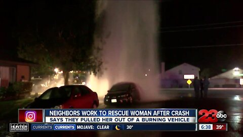 Neighbors work to rescue woman from burning vehicle