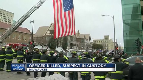 People pay their respects during the police procession route