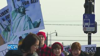 Demonstrators walk in Women's March 2018