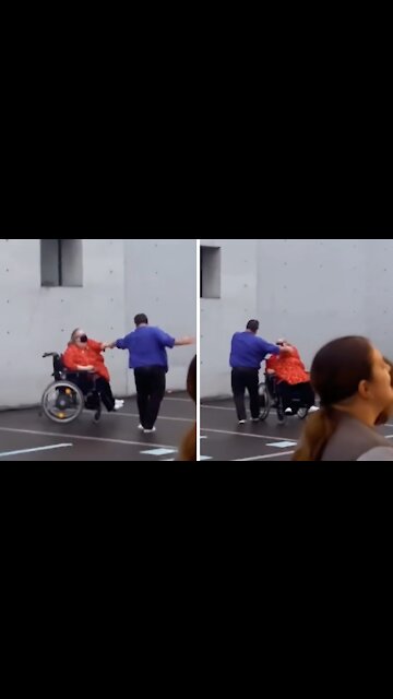 Woman in wheelchair dances with partner at concert