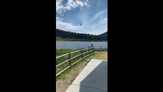 Air crane fills tanks while hovering over lake