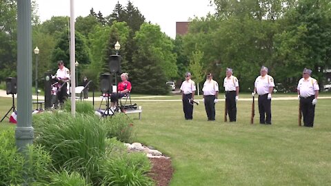 The community stood around the monument with their hands over their hearts as the Star Spangled Banner played.