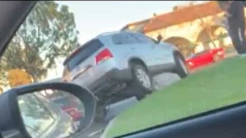 Driver parks car on top of a rock