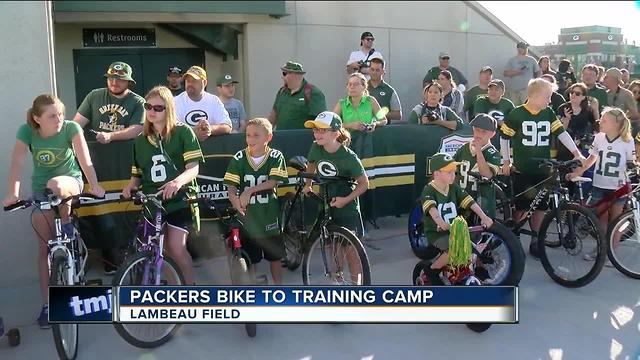 Packers players ride kids bikes to training camp practice