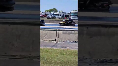 Nothing to see here, just a Snowmobile drag racing a Mustang!