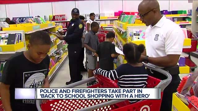 Police and firefighters take part in back to school shopping with a hero