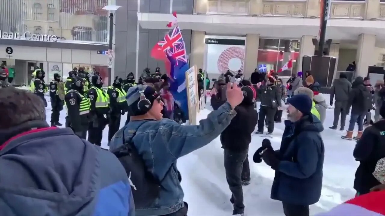 CANADIANS SING NATIONAL ANTHEM TO POLICE LINE