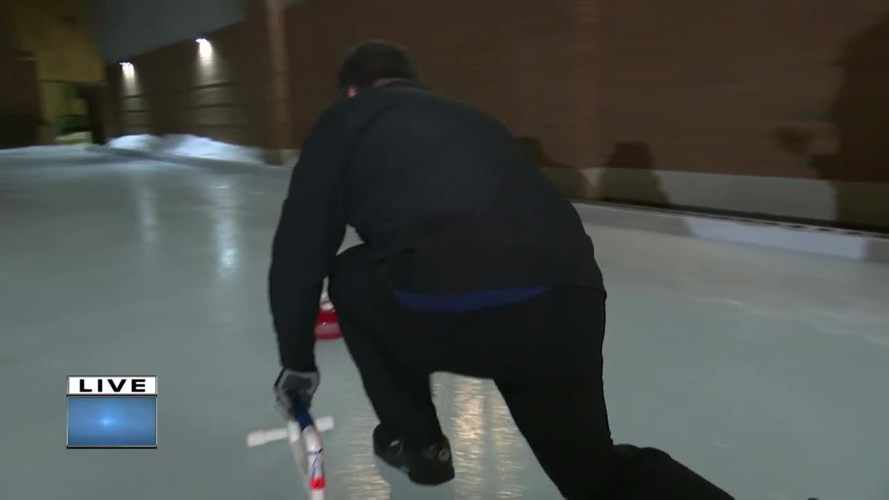 Trying out curling at the Sturgeon Spectacular