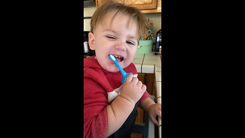 Baby brushes his teeth