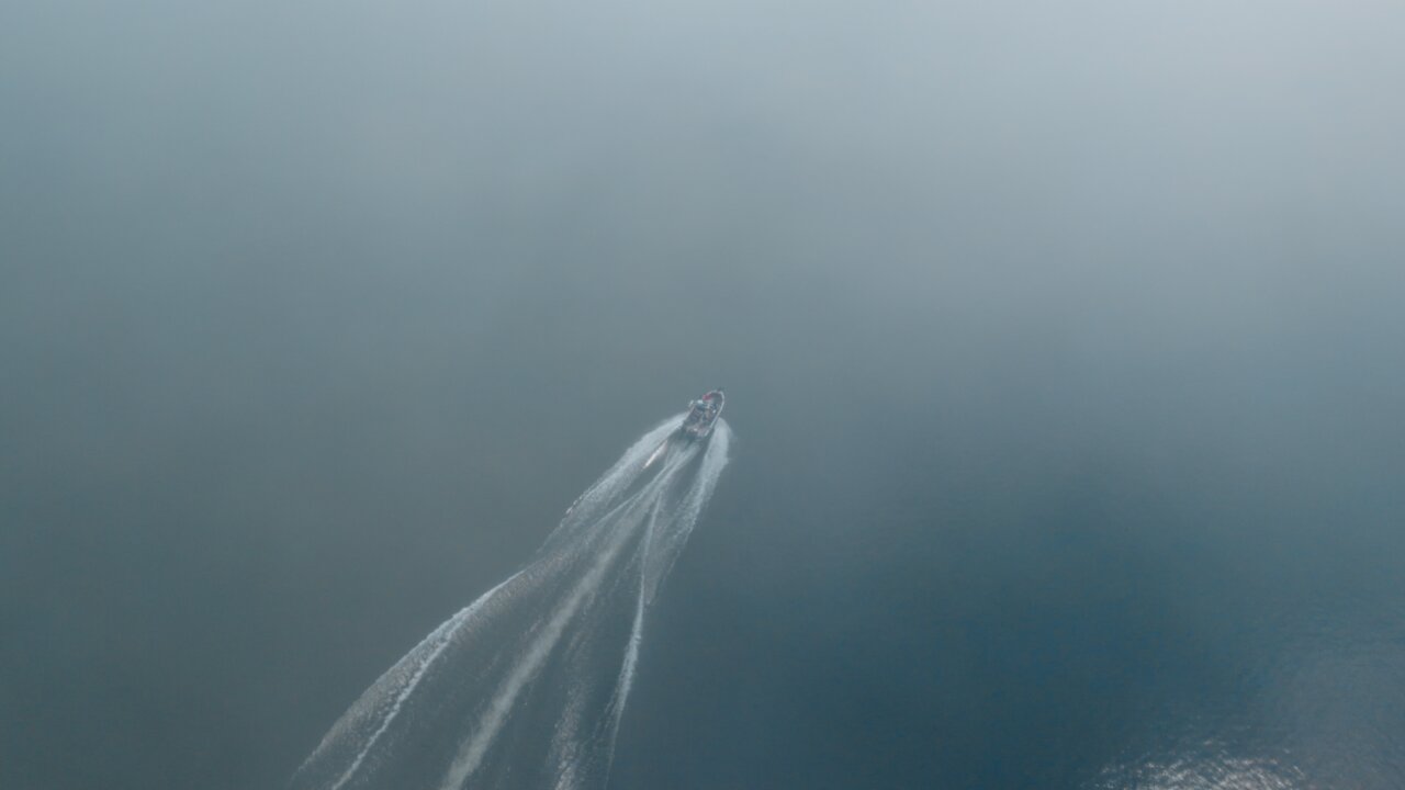 Boat Disappearing Into a Cloud of Fog