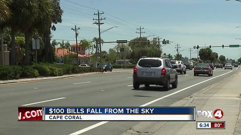 Large amounts of money was seen flying along a busy intersection in Cape Coral