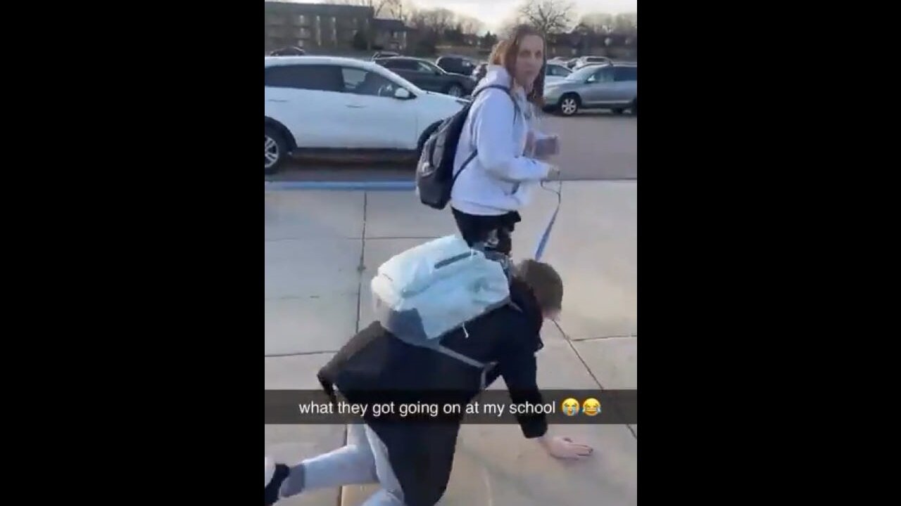 Student Walks Another Student Like A Dog Outside School