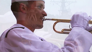 Musician plays Taps pierside of USS Fitzgerald (DDG 62)