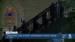 People pray the steps of the church of Immaculata