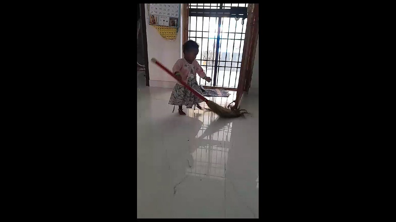 Cute little baby learning to clean home