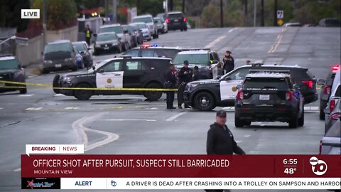 SDPD officer shot after pursuit, suspected gunman holed up in home